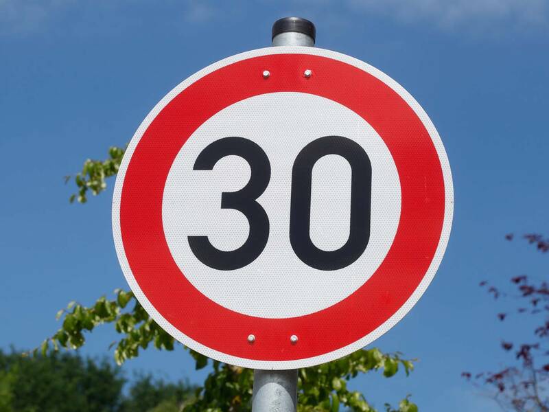 Verkehrsschild das auf eine Geschwindigkeitsbegrenzung von 30 km/h hinweist.